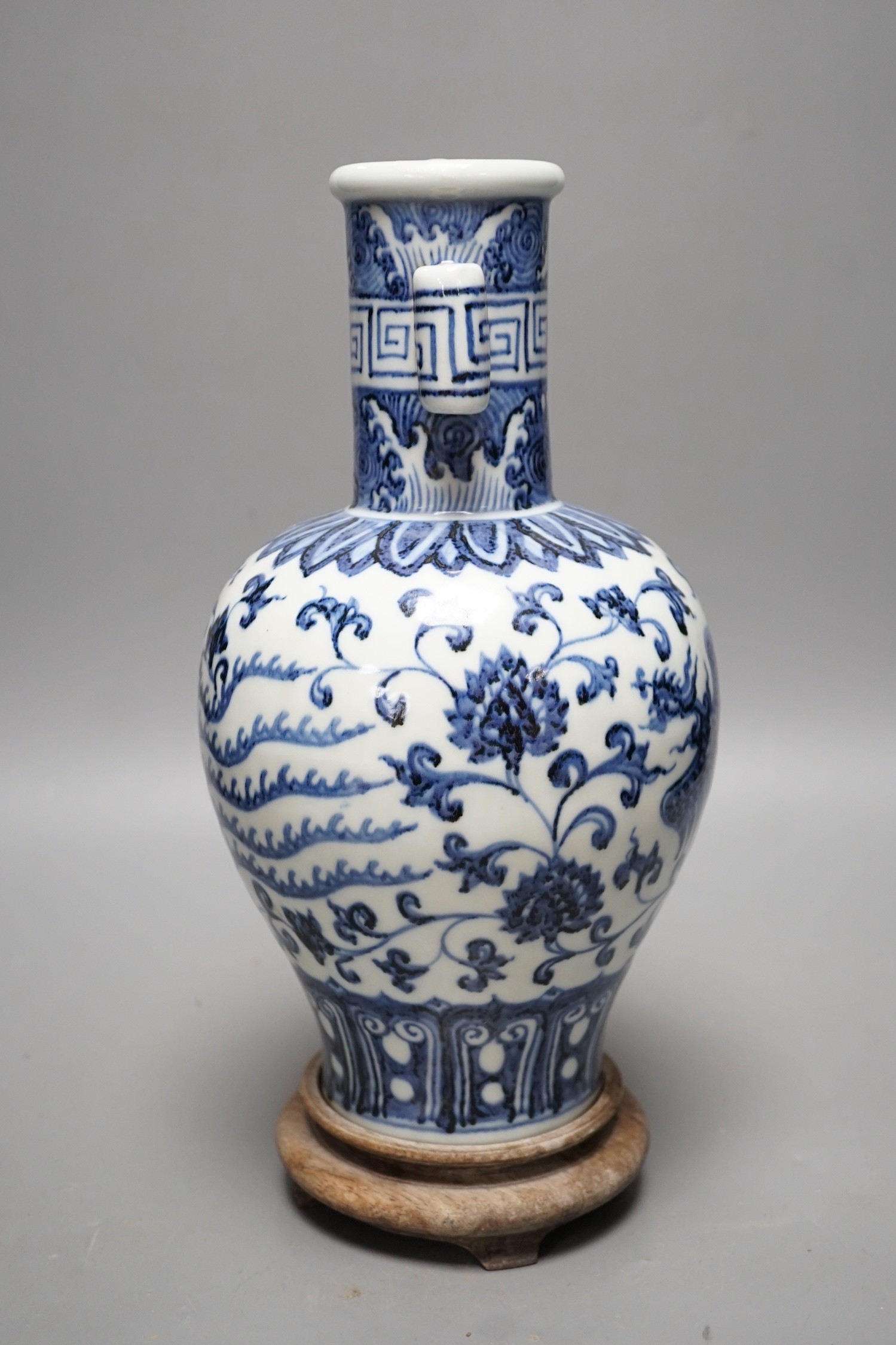 A Chinese blue and white vase on stand, 34cms high